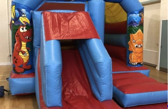 Our dino-themed inflatable slide and bouncy castle in a Colchester venue Dinosaur bouncy castle and slide hire in Colchester
